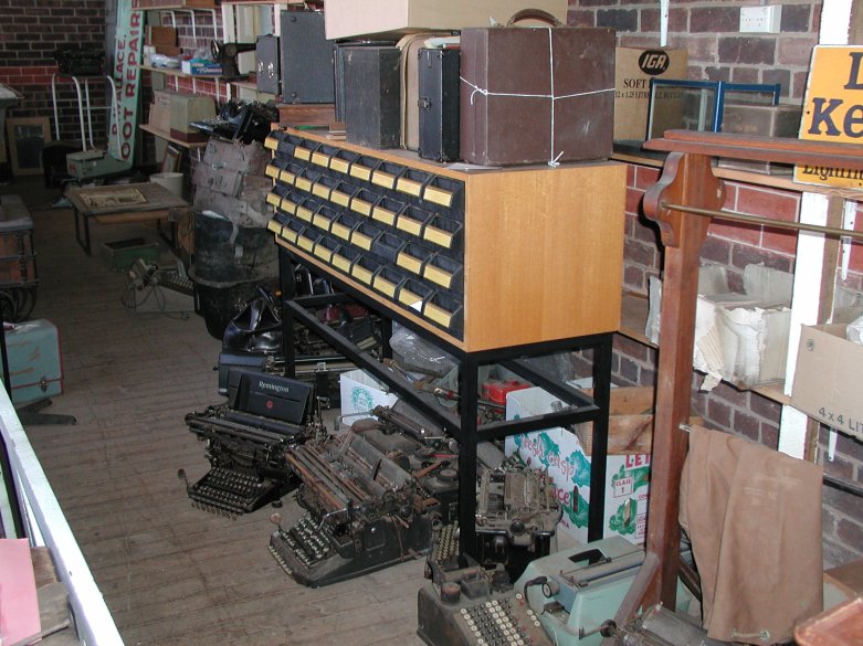 Typical typewriter breeding habitat. Note the typewriters lurking under the card index accompanied by their close relative, the adding machine