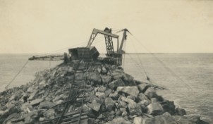 Damage to the Telpher crane and breakwall following a cyclone in early 1938. NQBP Collection